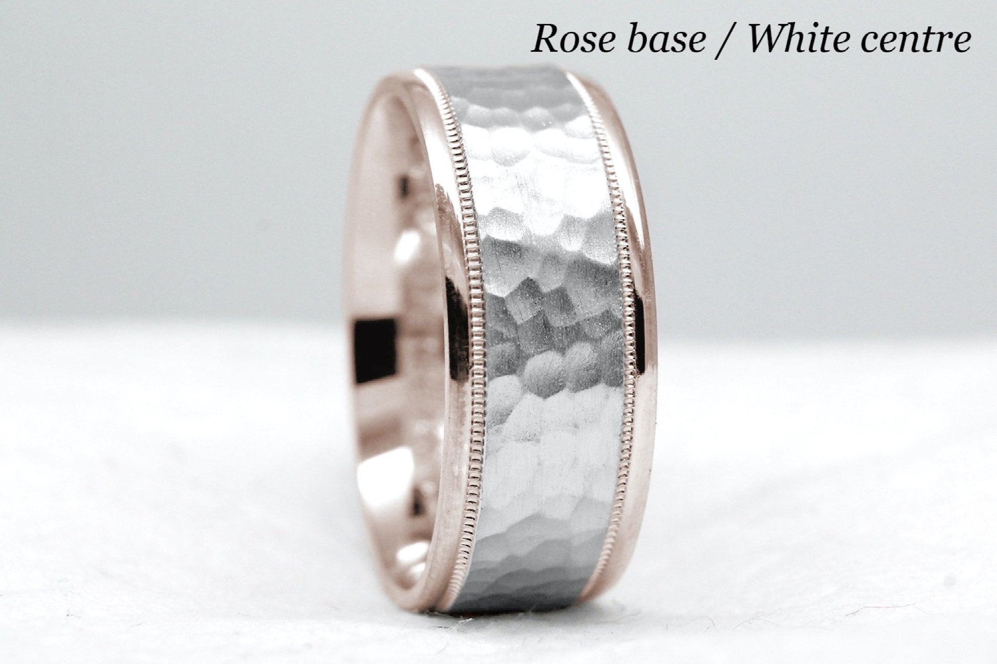 rose gold base and white gold centre. 8mm hammered wedding band for men and women