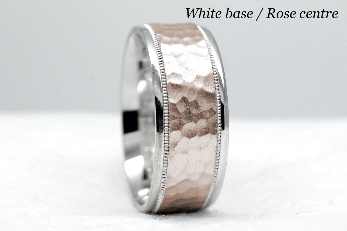 white gold base and rose gold centre. 8mm hammered wedding band for men and women