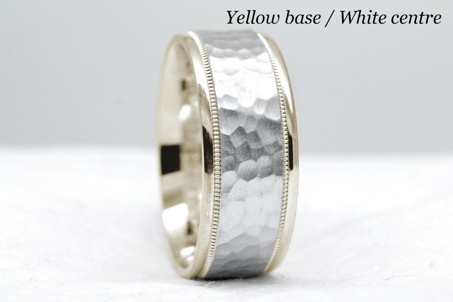 yellow gold base and white gold centre. 8mm hammered wedding band for men and women