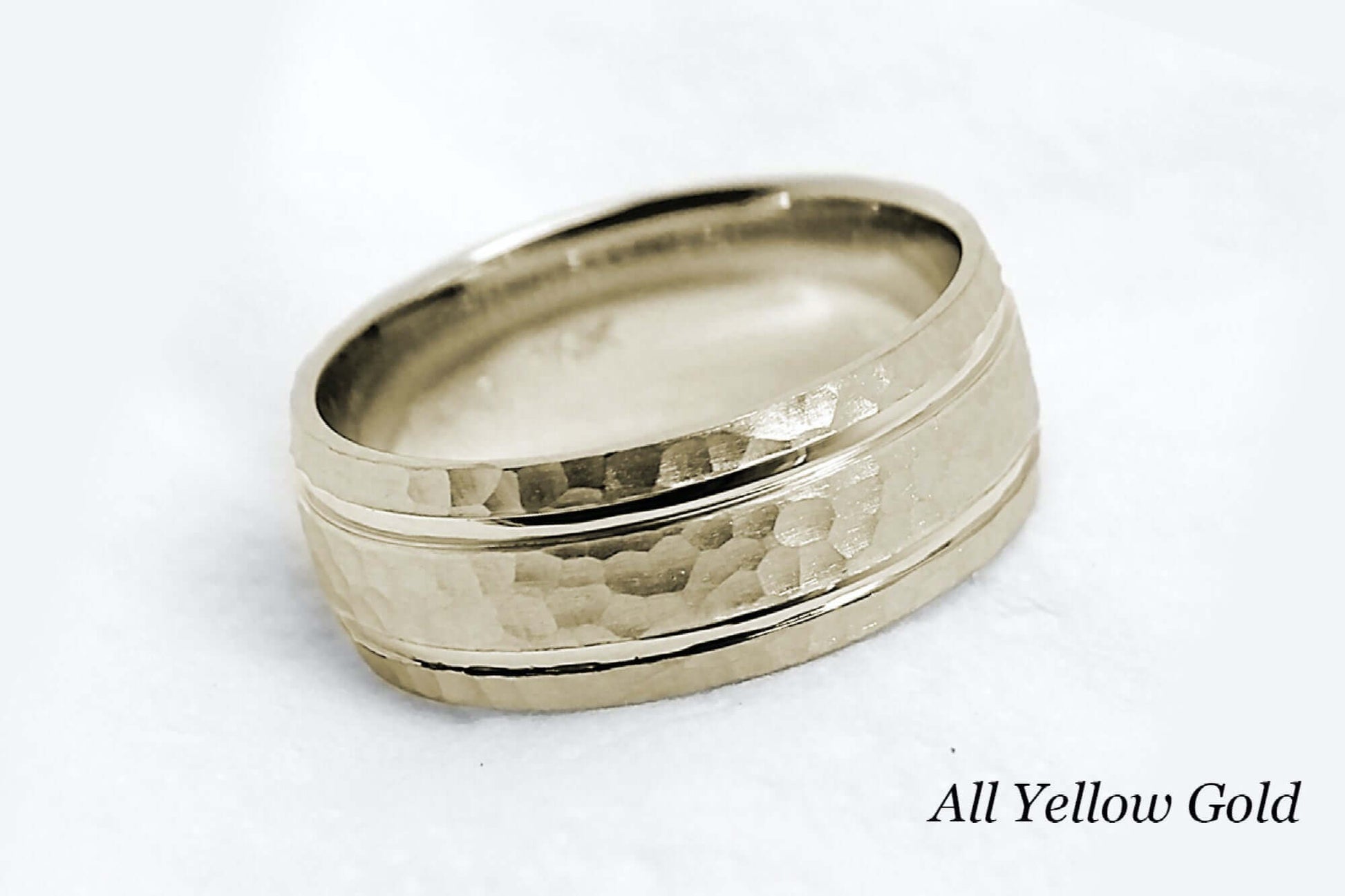 8mm wide Solid yellow gold ring for men featuring hammered finish and polished lines. Low dome look with comfort fit.