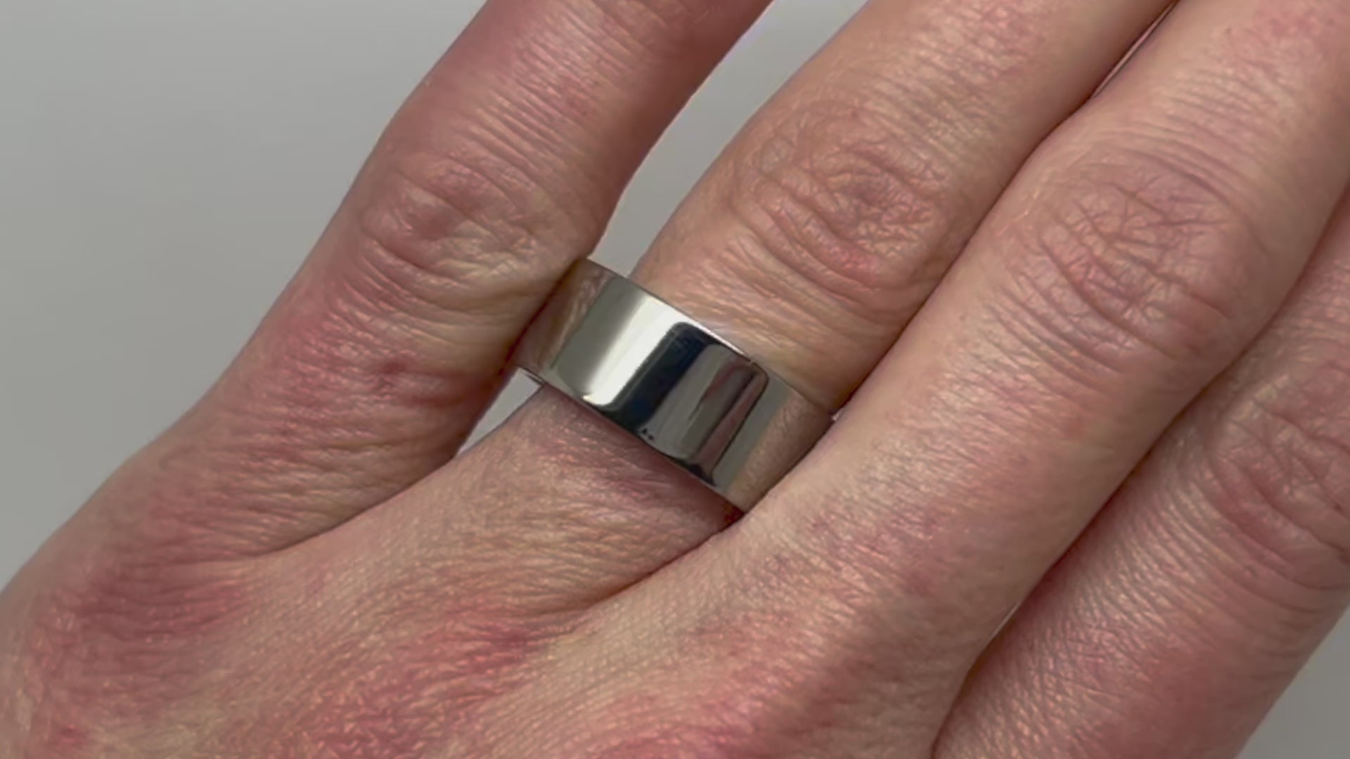 Flat Polished Titanium Ring in 8mm width on the finger