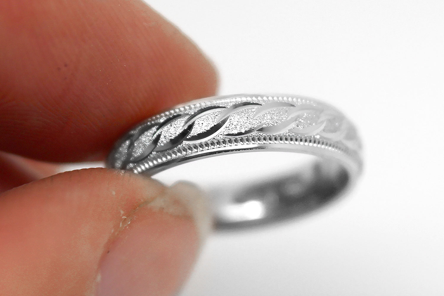 4mm solid 925 sterling silver wedding band in white gold, featuring stone finish centre with incut moons design and milgrain edge
