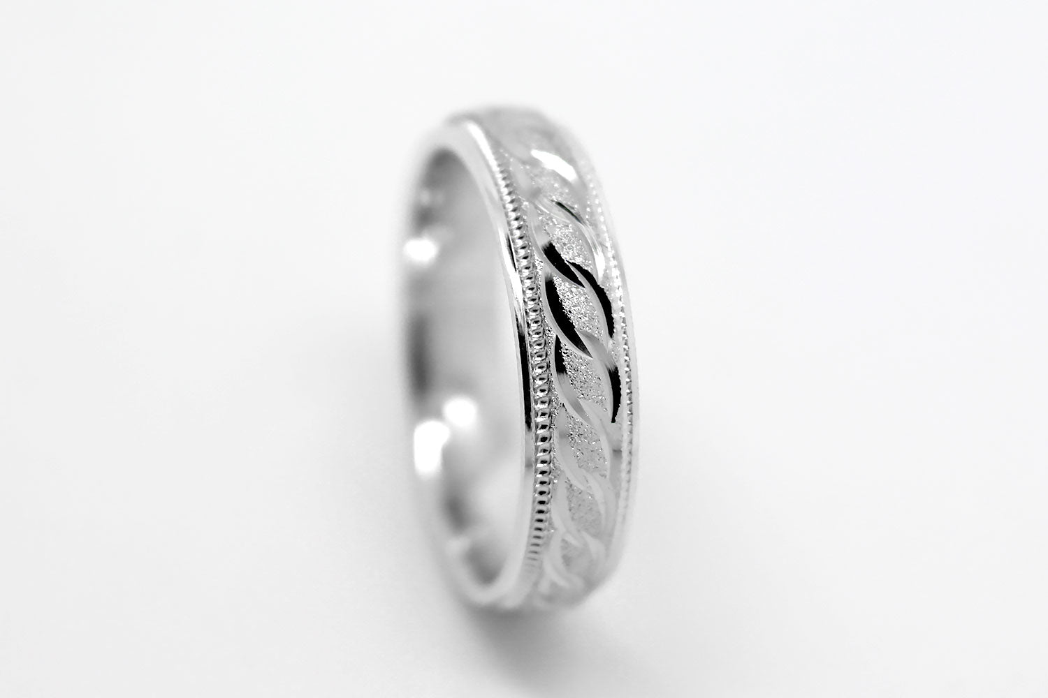 4mm solid 925 sterling silver wedding band in white gold, featuring stone finish centre with incut moons design and milgrain edge