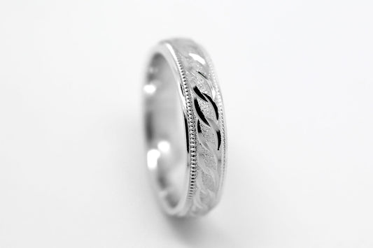 4mm solid 925 sterling silver wedding band in white gold, featuring stone finish centre with incut moons design and milgrain edge