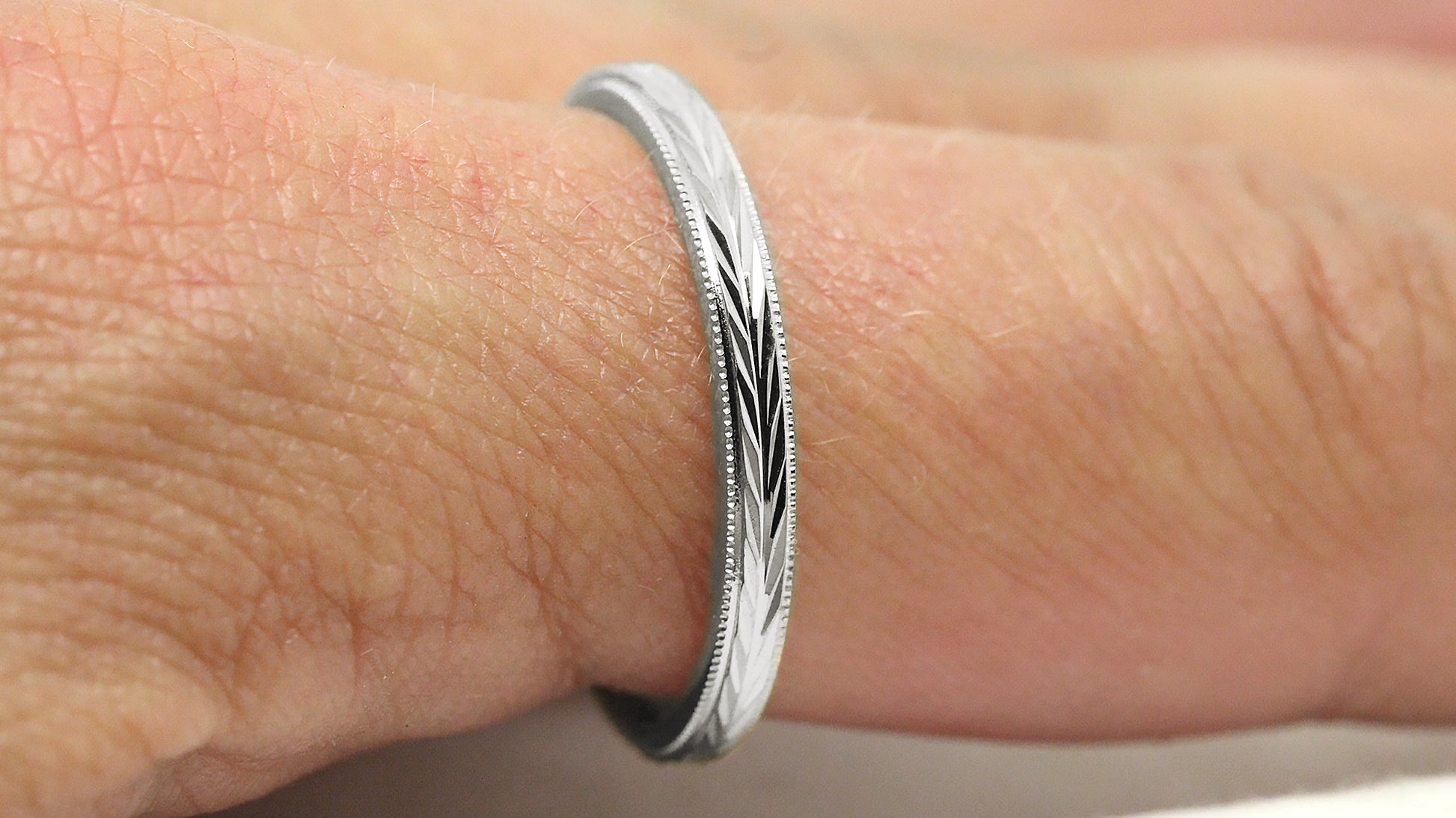 silver women's wedding ring with reflective filigree